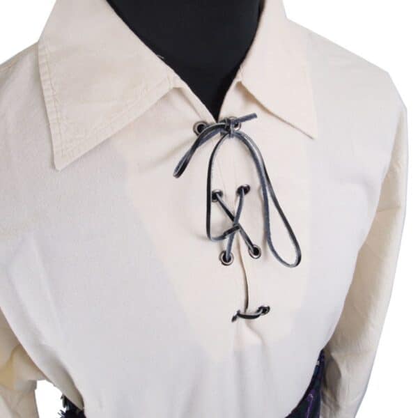 Close-up of the cream-colored Premium Jacobite Shirt with a pointed collar and black lace-up front detail, displayed on a black mannequin.