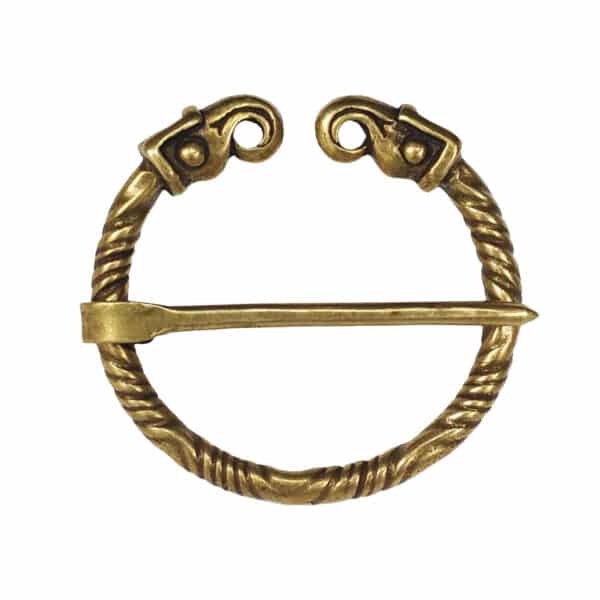 The Falcon Penannular Brooch is a brass accessory with a twisted circular frame and a straight pin, accented by decorative falcon heads at the ends.