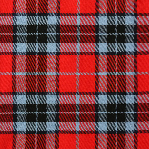 A red and blue plaid tartan fabric with a Learn to Play Bagpipe Book.