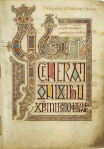An open book, inspired by the Lindisfarne Gospel, featuring an ornate design.
