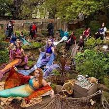 A group of Irish mermaids sitting in a garden.