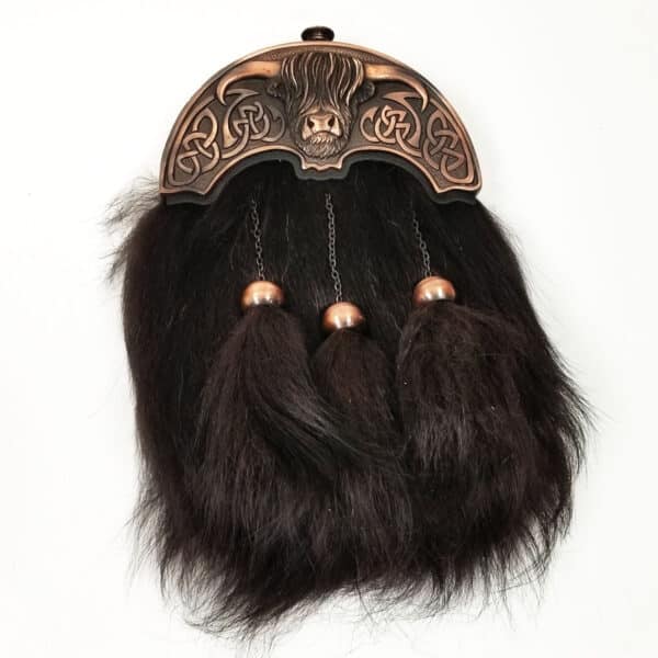 A Heilan Coo Premium Fur Sporran with ornate metalwork, featuring lion motif and tassels.