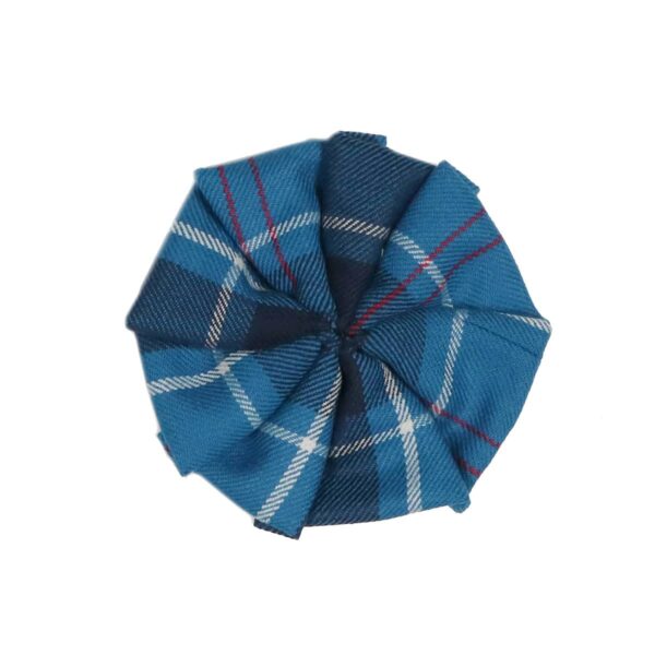 A blue and red plaid bow tie featuring U.S. Navy Tartan Light Weight Wool Rosettes 3in, placed on a white surface.