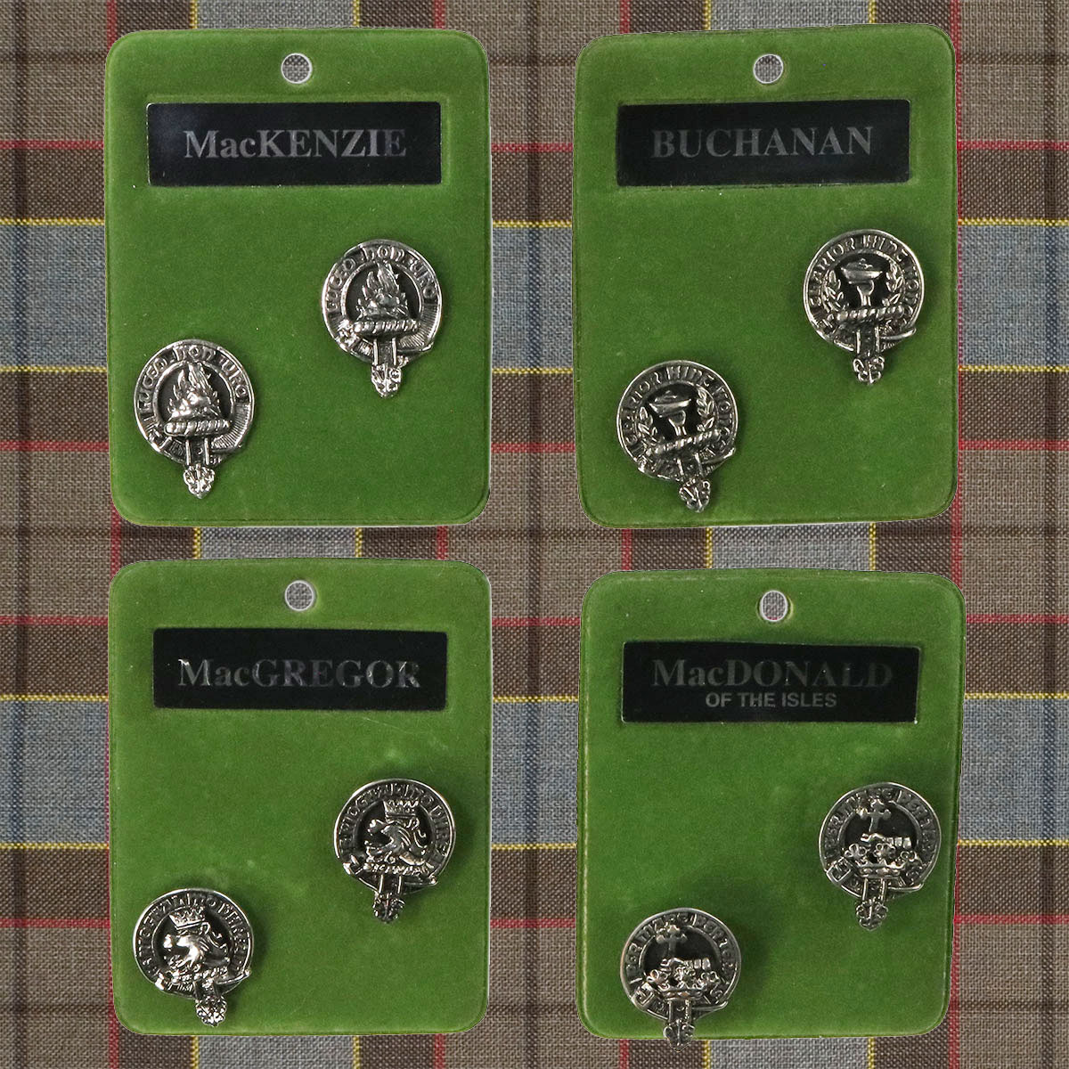 Four Art Pewter Clan Crest Cufflinks on a green plaid.