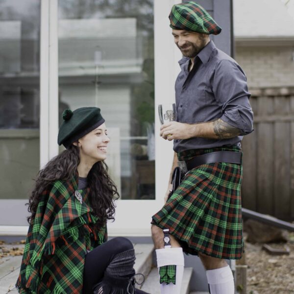 A man and woman dressed in kilts.
