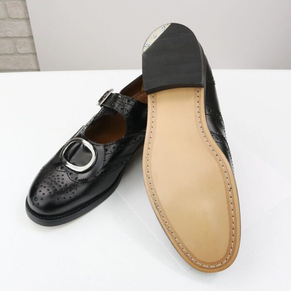 A pair of black Leather Buckle Brogues - Size 11 with a buckle on the toe.