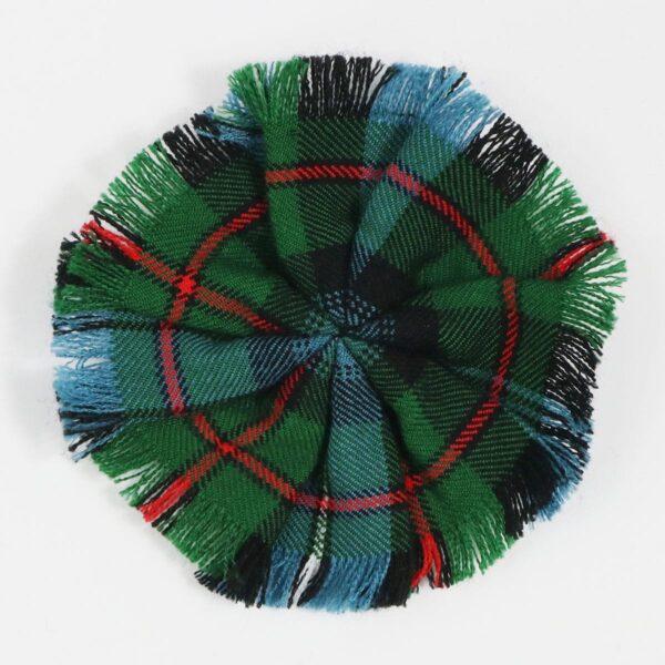 A Robertson Hunting Ancient Wool-Blend Tartan Rosette on a white surface.