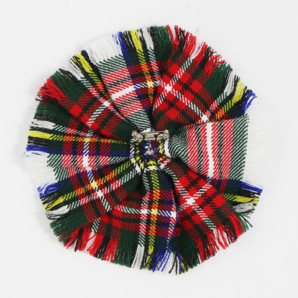 A Robertson Hunting Ancient Wool-Blend Tartan Rosette featuring a red, green, and blue flower on a white surface.