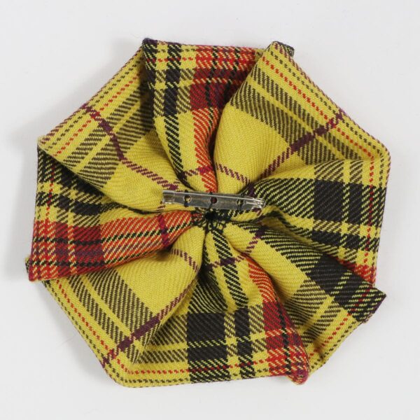 A yellow and black Morgan Welsh Tartan Rosette - Medium Weight Premium Wool brooch on a white surface.