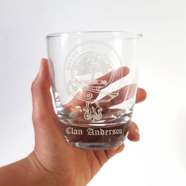 A person proudly holding up a Clan Crest 10 oz Lowball Rocks Whisky Glass.