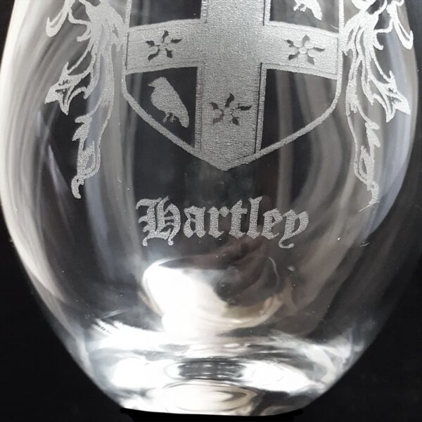 A Harley engraved Irish Coat of Arms stemless wine glass.