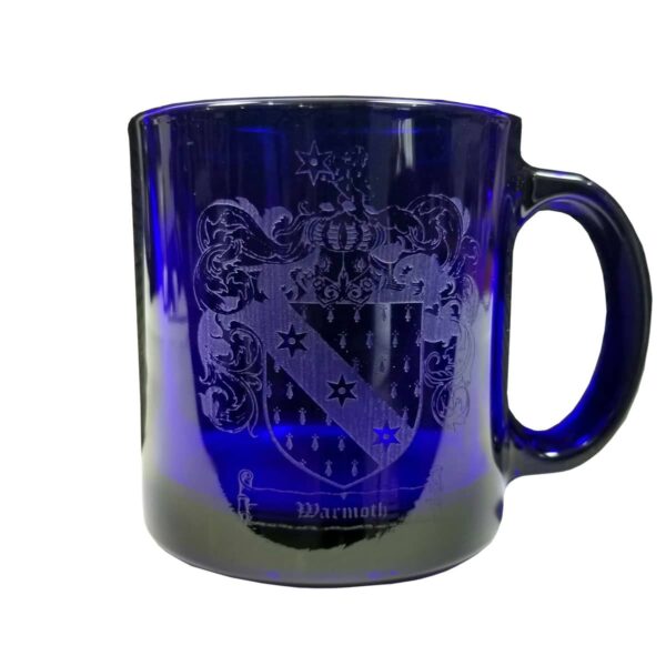A Warmoth Coat of Arms Coffee Mug - Engraved Blue Glass with a family crest printed on it.