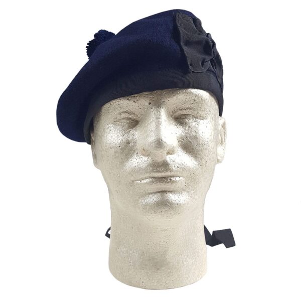 A mannequin wearing a navy blue felted wool Balmoral beret.