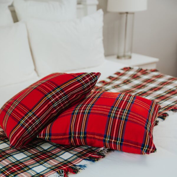 Two Stewart Dress Tartan Bed Runners - Homespun Wool Blend on top of a bed.