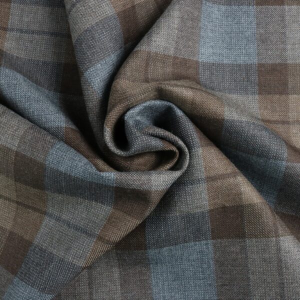 A close up of a premium wool Outlander Neck Warmer Cowl Scarf featuring blue and brown plaid fabric.