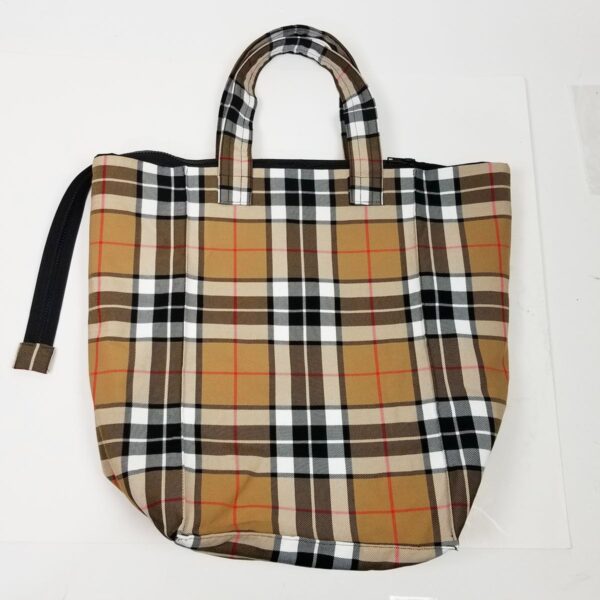 A Thompson Camel Modern Tartan Travel Bag - Poly/Viscose Wool Free in the iconic Burberry check pattern rests on a crisp white surface.