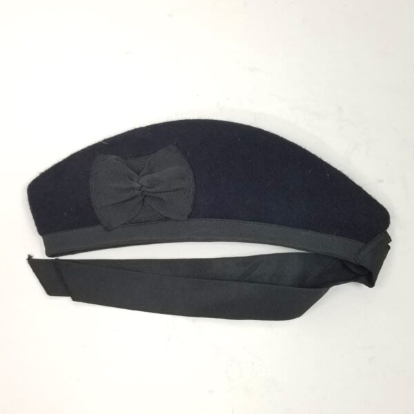 A black beret with a Dark Navy Blue Felted Wool Glengarry - Small 6.75 on it.