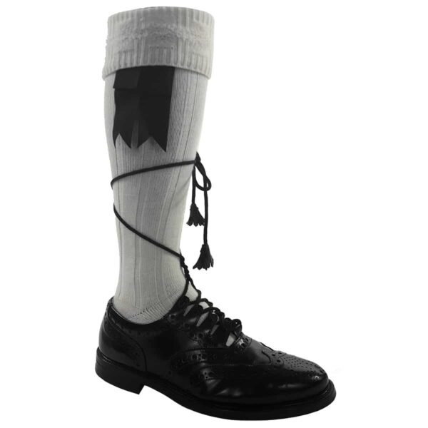 A pair of black and white socks with a tassel, perfect to be worn with Endrick Ghillie Brogues.