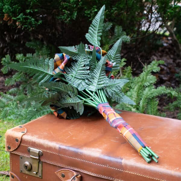 A Light Weight 11oz Premium Wool Tartan Rose Bouquet adorned with a bouquet of ferns.