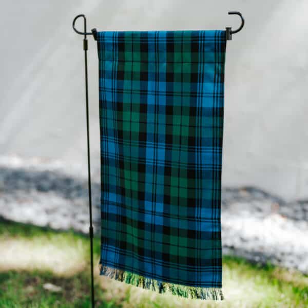 A Black Watch Ancient Tartan Garden Flag - Wool Free Poly/Viscose hanging on a pole.