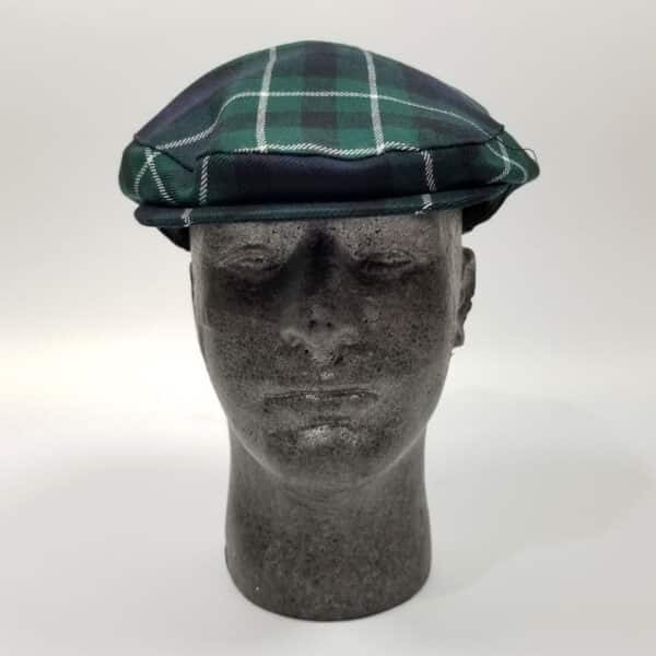 A mannequin wearing a green Graham of Montrose Modern Tartan driving cap.