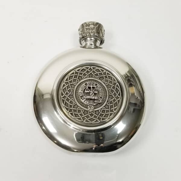 An Russell Clan Crest antiqued pewter flask adorned with a celtic design, featuring a clan crest.