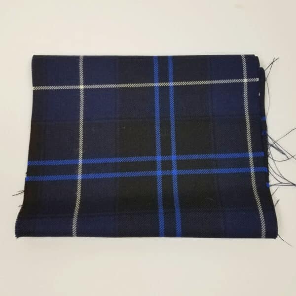A Patriot Modern Medium Weight Premium Wool Remnant - 9" x 57"-themed, blue and black plaid fabric on a white surface.