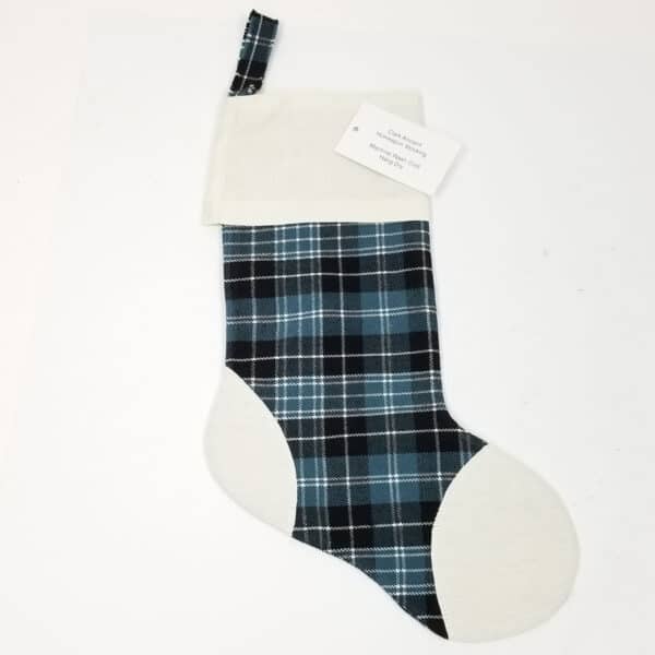 A Clark Ancient Tartan Stocking with Toes - Homespun Wool Blend hanging on a white surface.