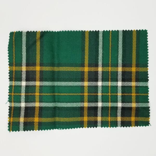 A Irish National Medium Weight Premium Wool Tartan Swatch in green and yellow plaid on a white surface.