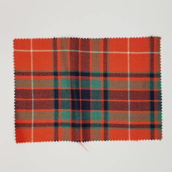 A Fraser Gathering Red Ancient Medium Weight Premium Wool tartan swatch in orange and green on a white surface.
