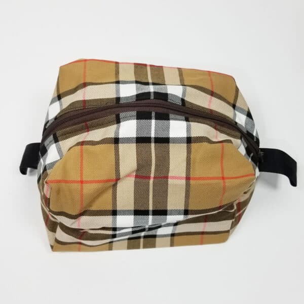 A Thompson Camel Large Tartan Box Pouch - Poly/Viscose Wool Free toiletry bag on a white surface.