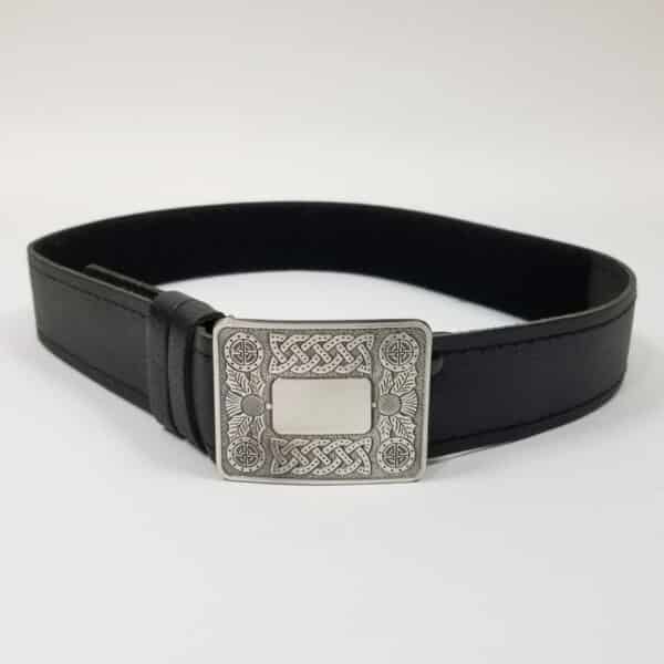 Child's Belt and Buckle Set: A child's black leather belt with an ornate buckle.