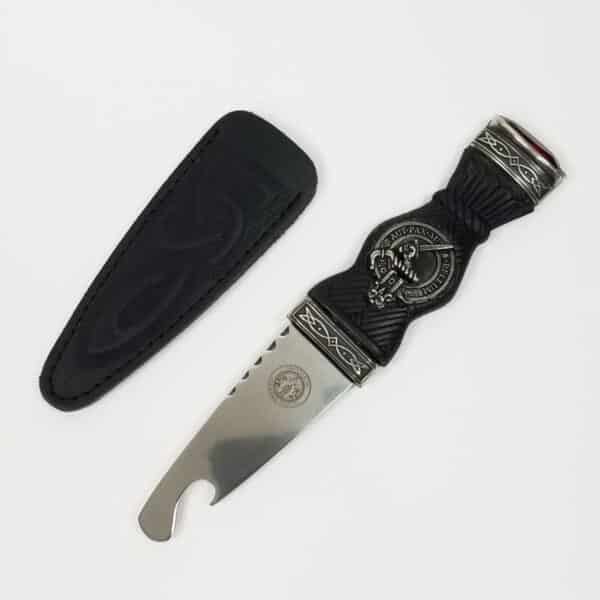 A black and silver Clan Crest Sgian Brew opener with a black leather sheath, perfect for opening Clan Crest brews.