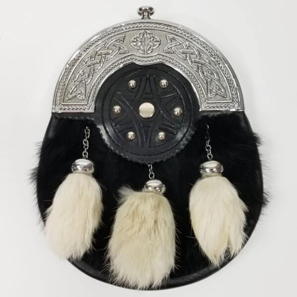 Decorative traditional Retired Rental Black and White Sporran with fur, celtic designs, and tassels on a white background.