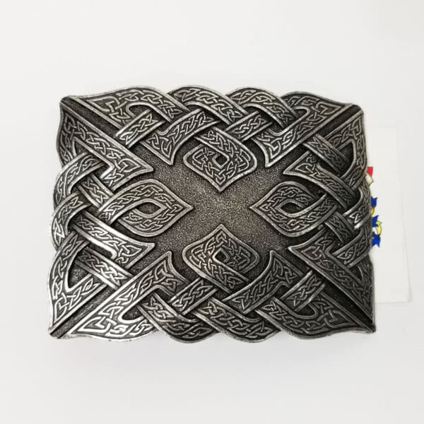 A decorative metallic Don McKee Celtic Knot Kilt Belt Buckle with intricate Celtic knot designs, isolated on a white background.