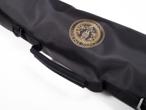 Deluxe black fabric carrying case with a handle, featuring a golden emblem with "Pacific Trillium Outdoors" and an illustration of mountains and trees on the side, named the Deluxe Kilt Carry Roll.