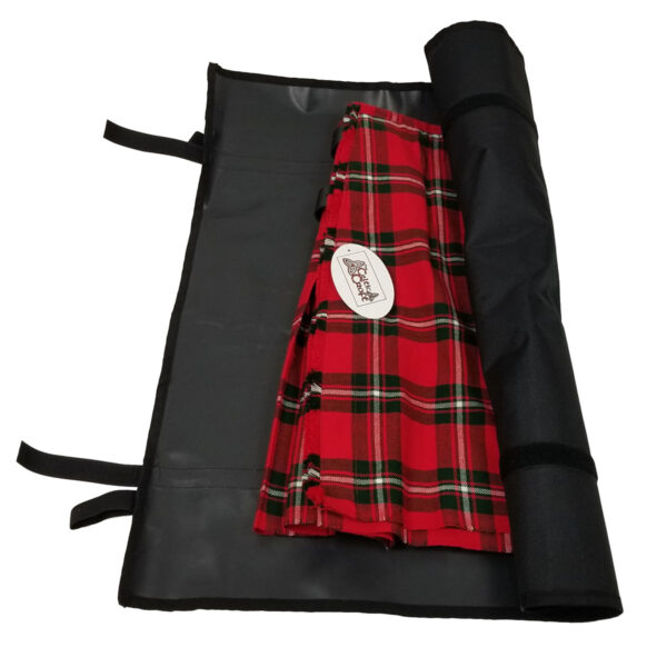 A black Kilt Carry Roll is open, revealing a red plaid kilt inside. The case, resembling a sleek carrying case, has securing straps and a folded flap.