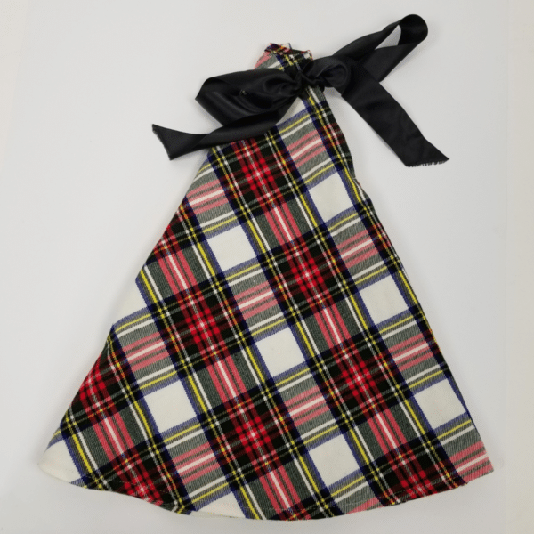 A gift bag made from the Stewart Dress Tartan Tree Skirt's homespun wool blend, featuring a plaid pattern with red, white, and yellow stripes and a black ribbon tie at the top.