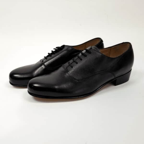 A pair of Oxford Dancing Brogues - 9.5, black leather dress shoes with laces, displayed on a white background.