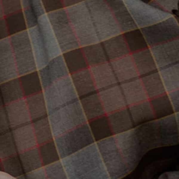 Close-up of an Official OUTLANDER Tartan - Wool-Free Remnants (Copy) fabric, featuring a pattern of red, blue, and beige squares.