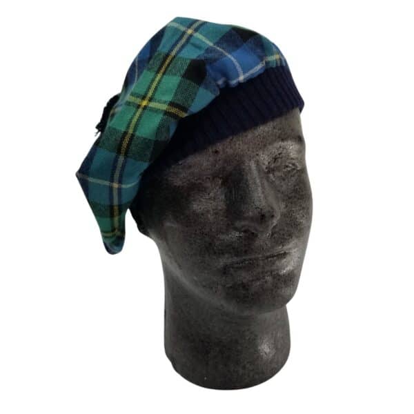 A mannequin head wearing a MacNeil Hunting Ancient Tartan Tam with a black band.