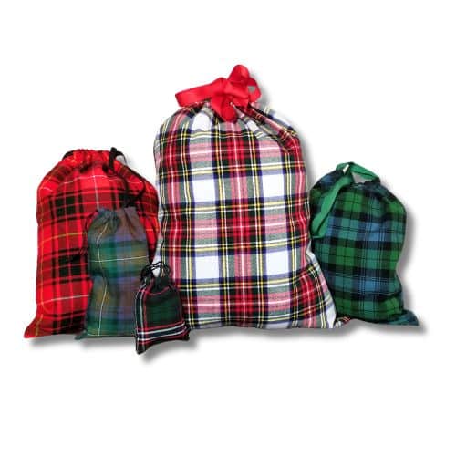 A set of four Santa Bags - Homespun Tartan, available in different sizes and colors, showcasing festive red and green plaid designs with practical drawstring closures.