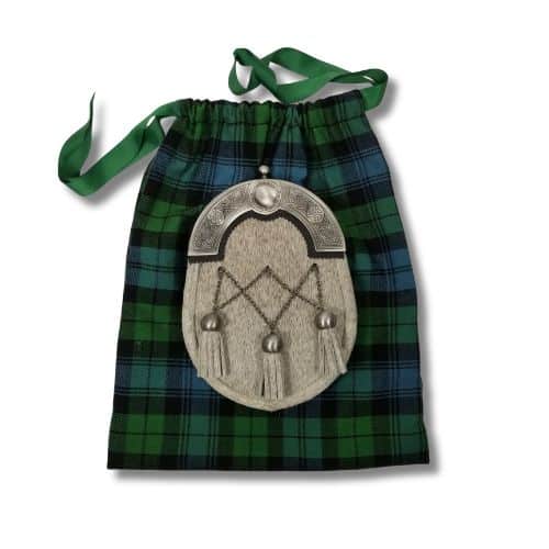 A traditional Scottish sporran with silver detailing rests on a Santa Bag in homespun green and blue tartan.