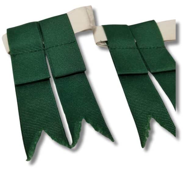 Close-up of a pair of Green Kids Flashes, featuring two green fabric ribbons with pointed ends attached to a white band. These accessories are ideal for adding a touch of charm to any outfit, offering a playful twist that kids will adore.