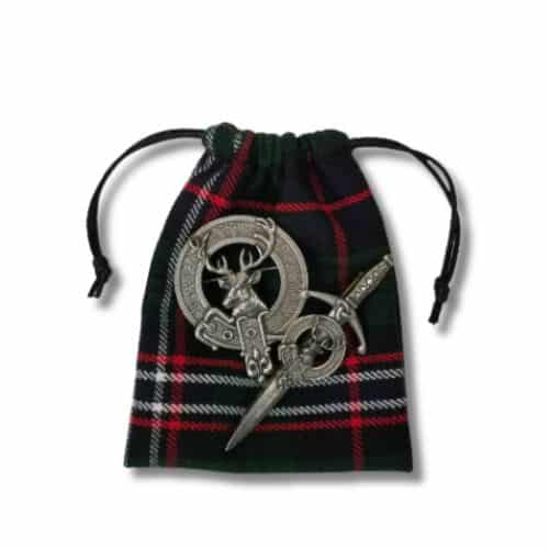 A Santa Bags - Homespun Tartan drawstring bag with two silver Celtic brooches placed on top, reminiscent of traditional Santa bags.