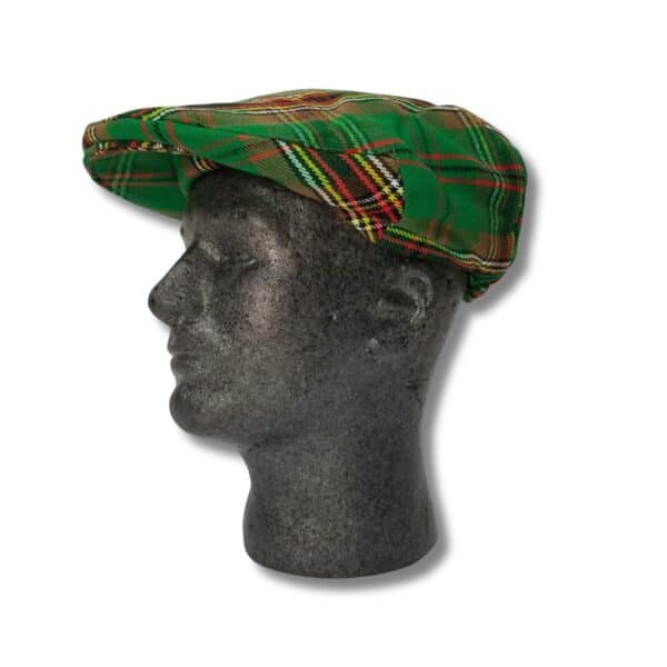 A mannequin head with a textured stone-like appearance adorned with a Stewart Dress plaid headband.