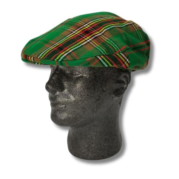 A Stewart Dress Headband (Copy) in plaid green elegantly displayed on a stone mannequin head.