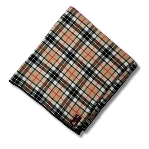 A Thomson Camel Horse Blanket featuring a folded fabric with a plaid pattern in beige, black, and red.