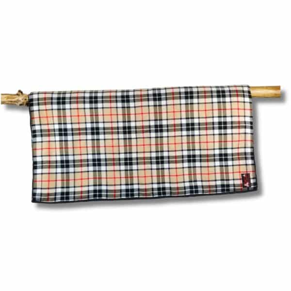 The Thomson Camel Horse Blanket, featuring a classic Thomson plaid design with red, black, and beige lines, is elegantly draped over a wooden rod.