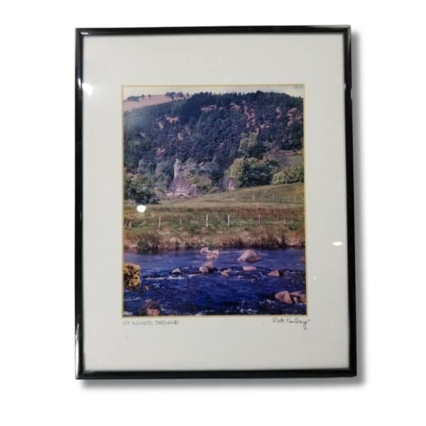 Framed photograph of a scenic landscape in St. Kevin's, Ireland, by Pat Conley, featuring a church ruin amid rolling hills and a small stream in the foreground.